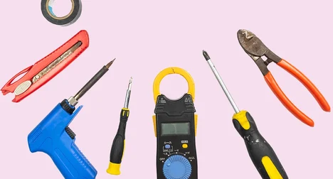A semi circle of tools against a pale pink background.