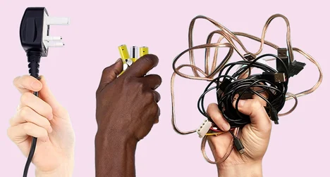 a light skinned hand holding a plug in the air, dark skinned hand holding a battery up in the air a light skinned hand holding a mass of cables up in the air all on a pink background
