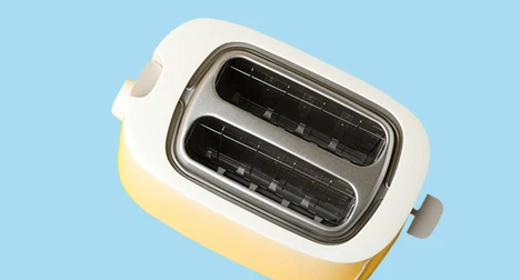 photo of a two slice toaster from above on a bright blue background