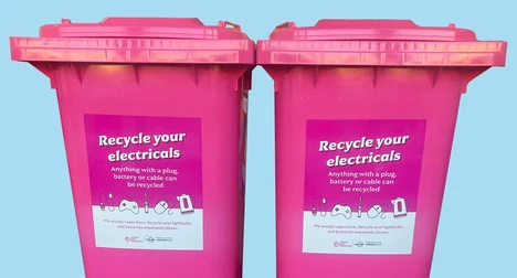 two bright pink kerbside electrical recycling bins