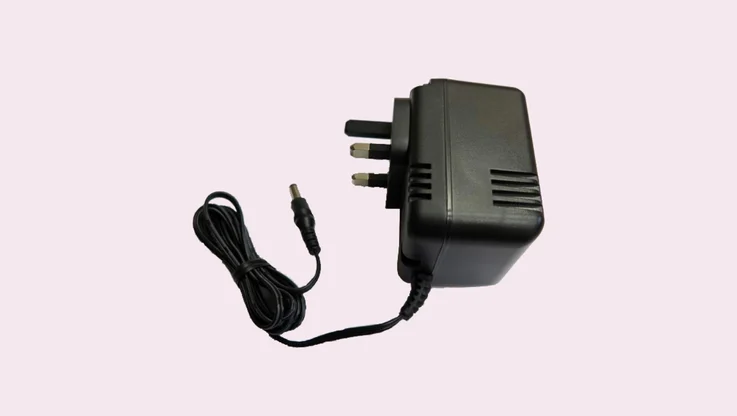 AC 3 pin to low voltage adapter on a plain background