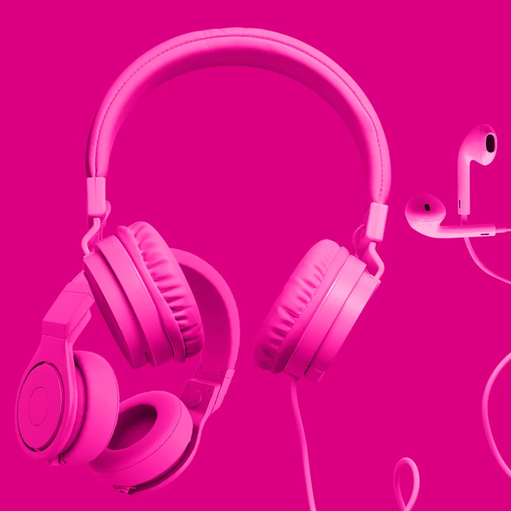 Floating headphones and headsets in a pink haze against a bright pink backdrop